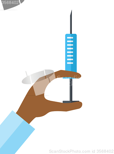 Image of Hand holding syringe.