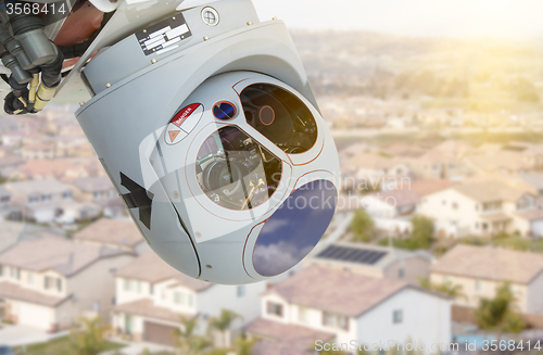 Image of Closeup of Drone Camera and Sensor Pod Module Above Neighborhood