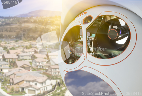 Image of Closeup of Drone Camera and Sensor Pod Module Above Neighborhood