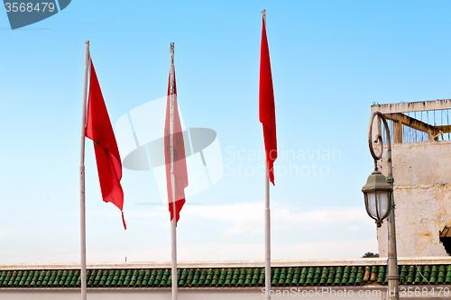 Image of tunisia  waving   in the blue sky   and battlements  wave