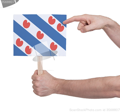 Image of Hand holding small card - Flag of Friesland