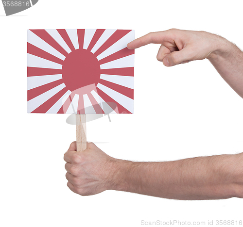 Image of Hand holding small card - Flag of Japan