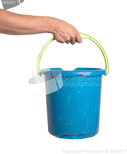 Image of Human hand holding empty plastic pail