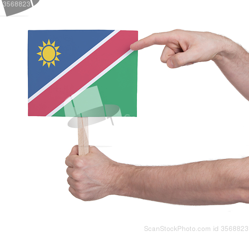 Image of Hand holding small card - Flag of Namibia