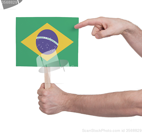 Image of Hand holding small card - Flag of Brazil