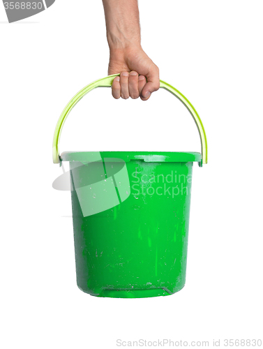 Image of Human hand holding empty plastic pail