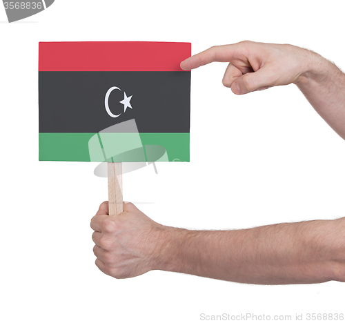 Image of Hand holding small card - Flag of Libya