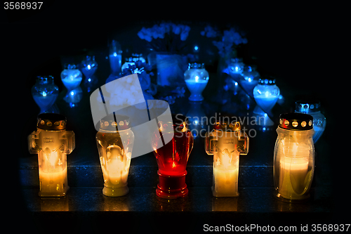 Image of Candles Burning At a Cemetery