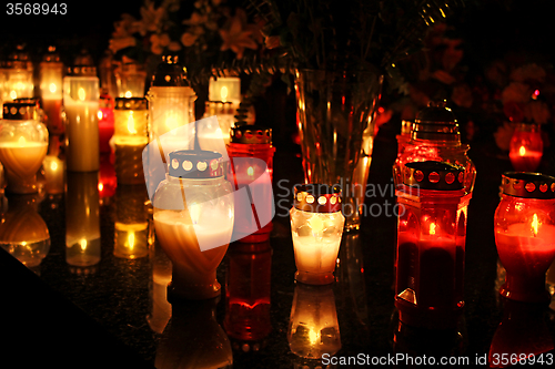 Image of Candles Burning At a Cemetery