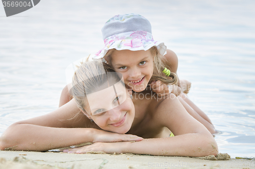 Image of Happy mother and daughter on the banks of the river