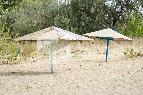 Image of Old metal beach umbrellas on the beach