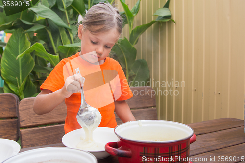 Image of Sleepy girl on breakfast places semolina