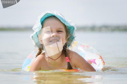 Image of Four-year girl bathes in the river