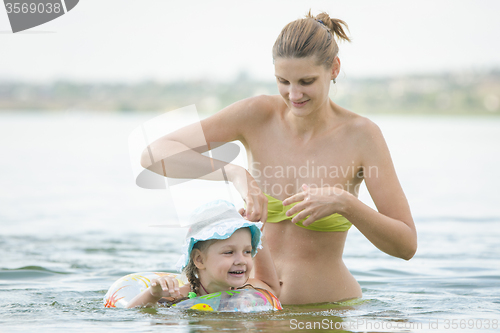 Image of Mom and daughter swimming in the river