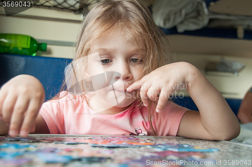 Image of Girl collects puzzles while on a train