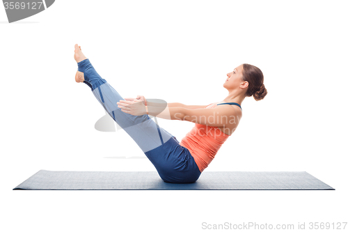 Image of Woman practices yoga asana Paripurna navasana