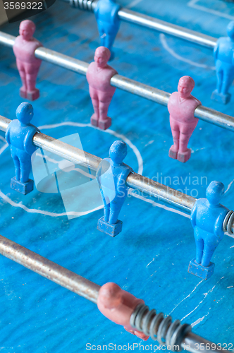 Image of football players and through slats of wood, a play for children