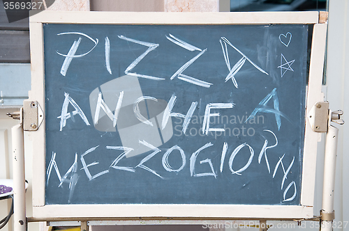 Image of Menu of a restaurant  where there is' wrote: "Pizza also lunch"