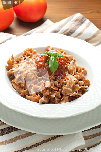 Image of 
Homemade pasta topped with tomato and Parmesan integral