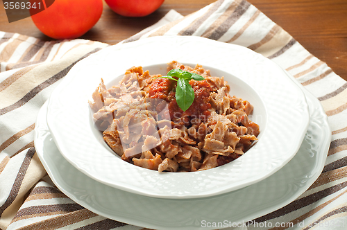 Image of 
Homemade pasta topped with tomato and Parmesan integral