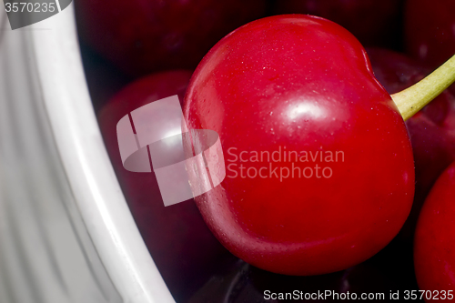 Image of Big ripe cherry in a ceramic vase.