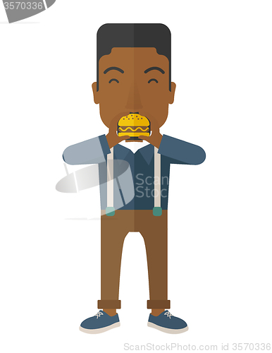 Image of Man eating hamburger. 