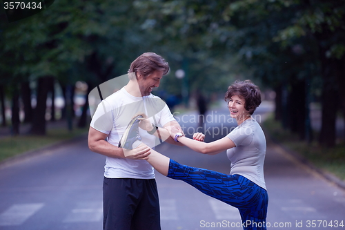 Image of jogging couple stretching