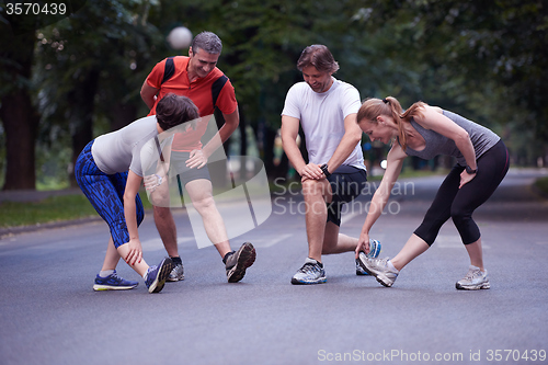 Image of jogging people group stretching