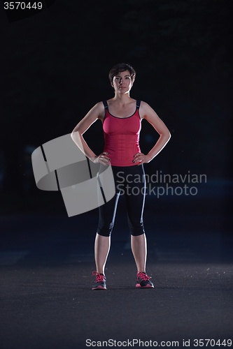 Image of woman  stretching before morning jogging