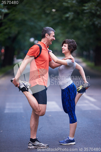Image of jogging couple stretching