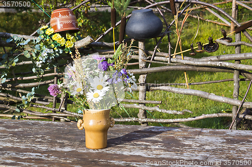 Image of Bouquet of flowers in vase on rustic table