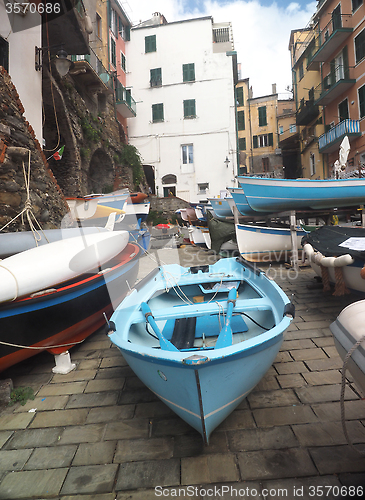 Image of Riomaggiore   Cinque Terre Italy  old fishing boats on street wi