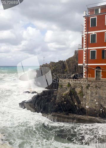 Image of l Riomaggiorre Cinque Terre  old building raging stormy sea  cli
