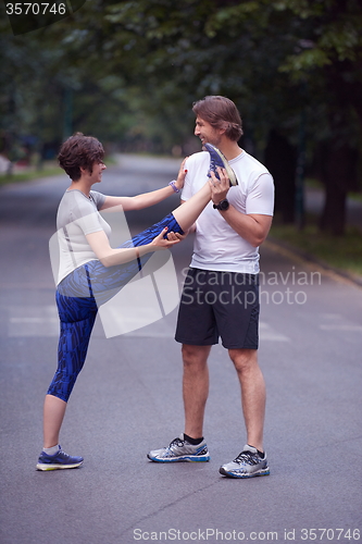 Image of jogging couple stretching