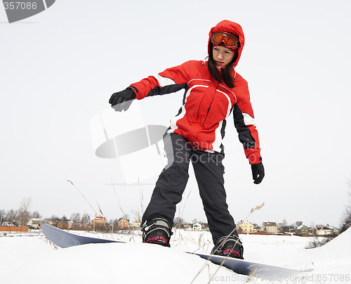 Image of young adult female snowboarder