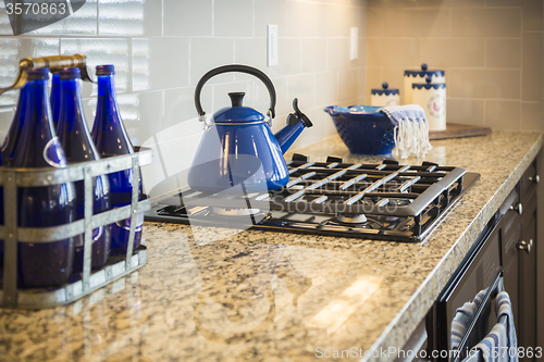 Image of Marble Kitchen Counter and Stove With Cobalt Blue Decor