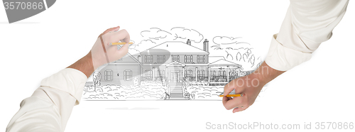 Image of Male Hands Sketching A Beautiful House