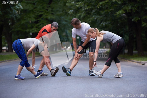 Image of jogging people group stretching