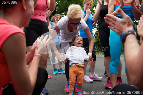 Image of jogging people group have fun with baby girl