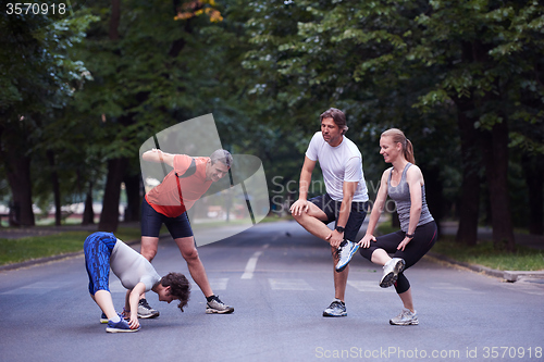 Image of jogging people group stretching