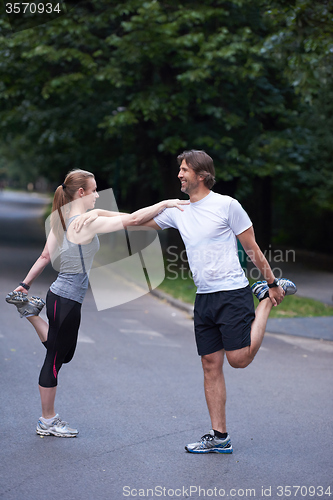 Image of jogging couple stretching