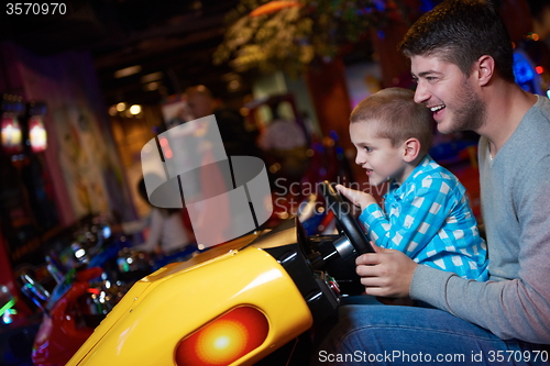 Image of father and son playing game in playground