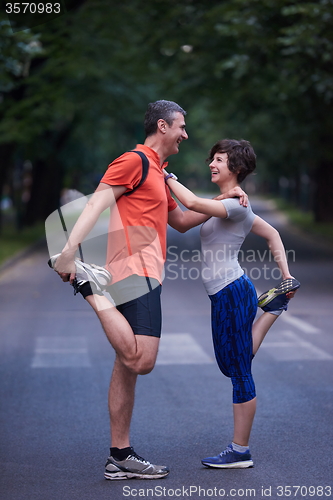 Image of jogging couple stretching