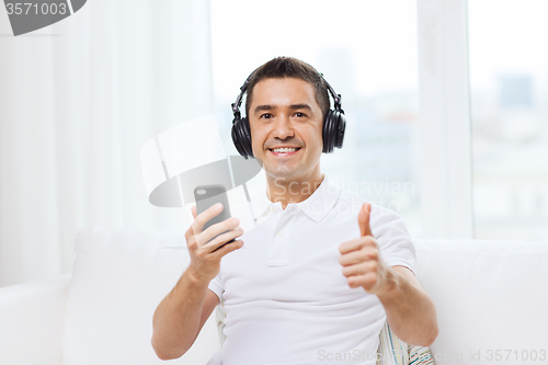 Image of happy man with smartphone and headphones