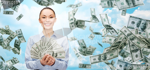 Image of smiling businesswoman with dollar cash money