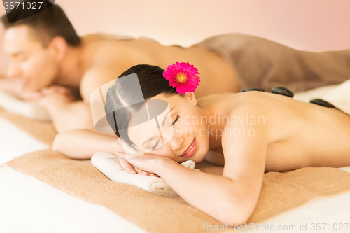 Image of couple in spa with hot stones