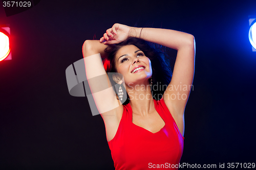 Image of beautiful sexy woman in red dancing at nightclub