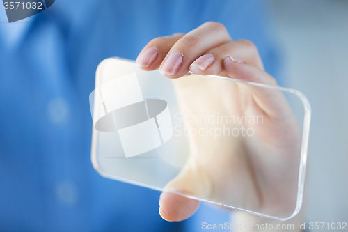 Image of close up of woman with transparent smartphone