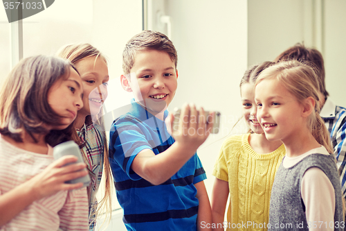 Image of group of school kids with smartphone and soda cans