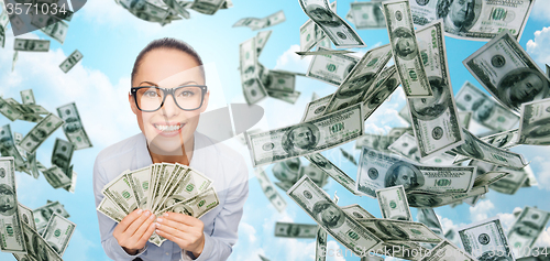 Image of smiling businesswoman with dollar cash money